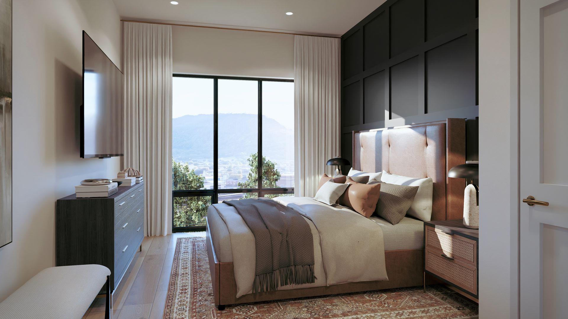 Bedroom with a paneled accent wall and valley view